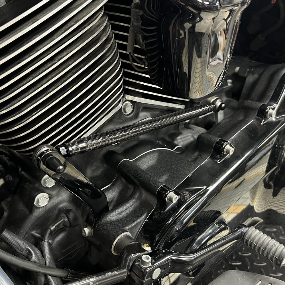 Carbon fiber adjustable Harley shifter linkage for Touring and Softail models, CNC billet aluminum with no-slop shifting.